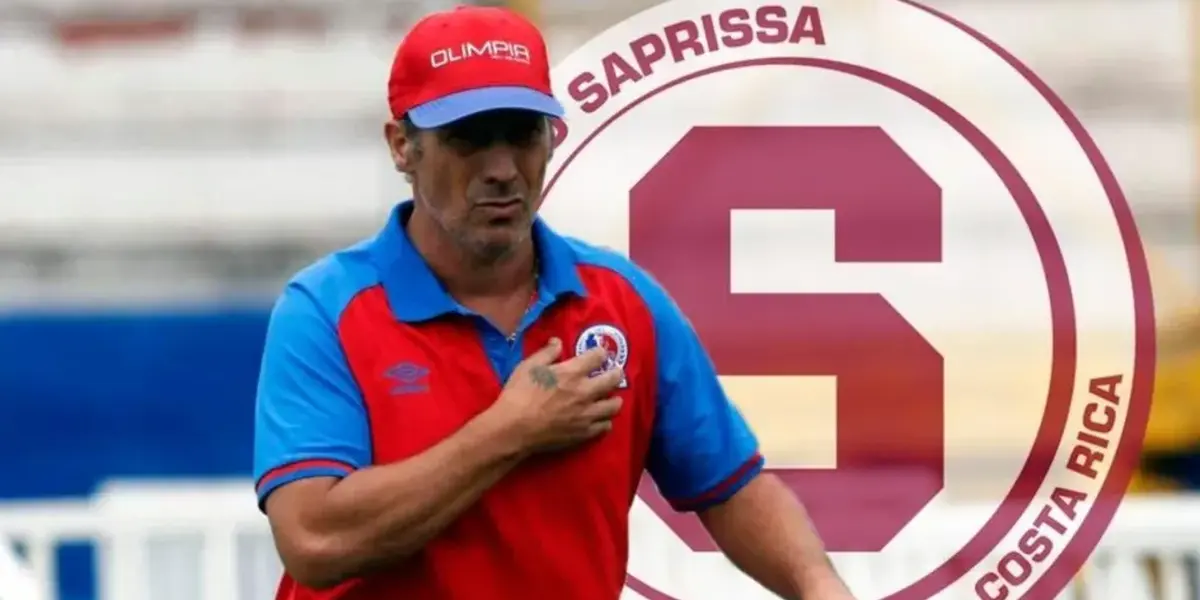 Pedro Troglio visitiendo la camiseta de Olimpia con el escudo de Saprissa atrás. Foto: Fútbol Centroamerica.